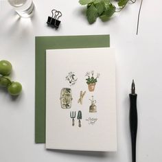 a greeting card with plants and utensils on it next to a fountain pen