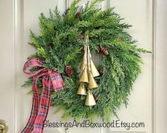 a christmas wreath with bells hanging from it