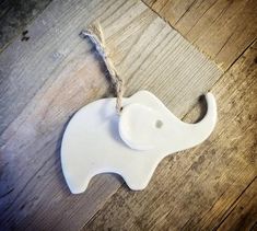 an elephant ornament hanging on a wooden floor