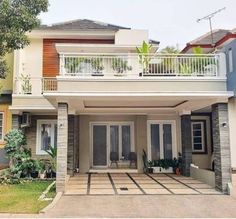 a two story house with balconys and balconies