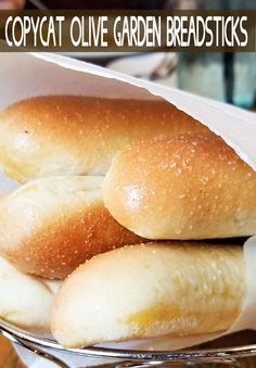 three loaves of bread sitting on top of a glass plate with the words copycat olive garden breadsticks