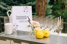 lemons are sitting on a table next to champagne glasses and a sign that says lemonade station