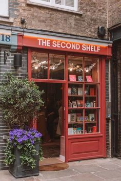 the second shelf store is open for customers to see their favorite books in it's red display case