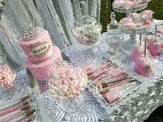 a table topped with lots of pink and white candy