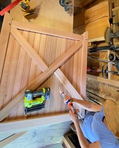 a woman is working on some wood