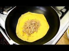 an omelet is being cooked in a pan on the stove