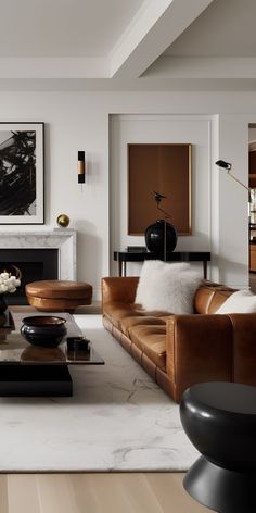 a modern living room with leather furniture and art