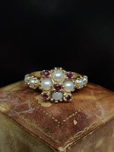 This beautiful vintage ring dates to circa 1970s featuring a statement cluster of natural pearl and ruby gemstones set in a decoratively fashioned 14ct yellow gold mount hallmarked for London.  UK size - O US size - 7 Weight approx - 3.1 grams Message me any questions 1970 Wedding Ring, Engagement Pearl Ring, Pearl And Ruby Ring, Non Traditional Engagement Rings Vintage, Pearl Engagement Ring Vintage, 1970s London, Ruby Jewelry Ring, Diamond Earrings Indian, Vintage Cluster Ring