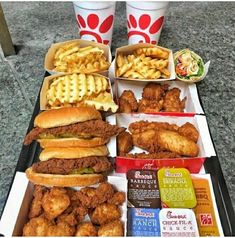 some chicken sandwiches and waffle fries on a tray