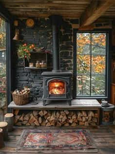 a wood burning stove sitting inside of a living room next to a firewood pile