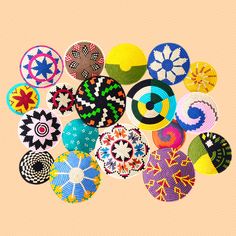 an assortment of colorful circular objects on a pink background