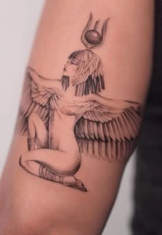 a woman's arm with an angel tattoo on it