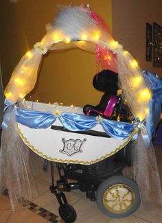 a baby carriage decorated with lights and tulle