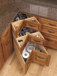 an open drawer in the corner of a kitchen