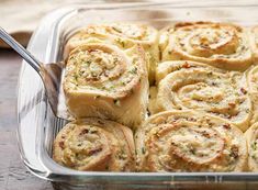 a glass casserole dish filled with rolls