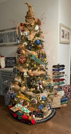 a small christmas tree decorated with ornaments and ribbons