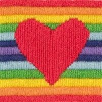 a patch with a red heart on top of multi - colored strips in the shape of a rainbow