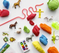 various toys and crafts laid out on a white surface