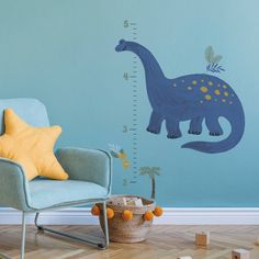 a child's room with a blue dinosaur growth chart wall decal on the wall