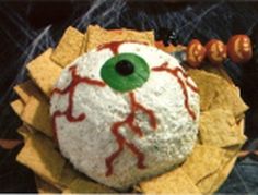 an eyeball is sitting on top of some tortilla chips