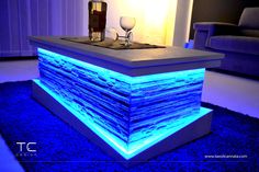 a table that is lit up with blue lights and some glasses on top of it