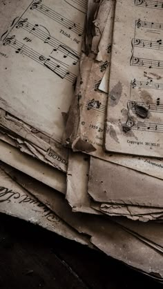 old music sheets are piled on top of each other