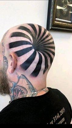 a man with black and white stripes on his face has a tattoo on his head