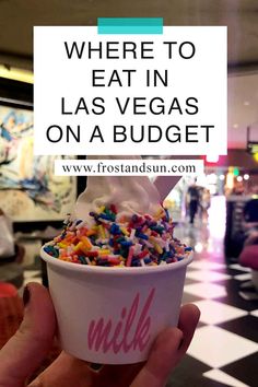 a person holding up an ice cream cone with sprinkles in it and the words where to eat in las vegas on a budget