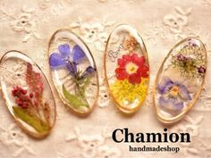 four glass cabs with flowers on them sitting on a lace tablecloth and the words chamon handmade shop