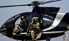 Blackwater private security guards scan Baghdad from their helicopter. Photograph: Marwan Naamani/AFP/Getty Images Canadian Military, The Boogeyman, Us Government, Black Water, U.s. States, Baghdad