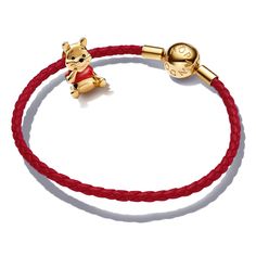 Joy. Kindness. Honey! Spread love the Pooh way with this vibrant Pandora bracelet set featuring the Disney Winnie the Pooh Bear Charm in 14k gold plating with red enamel shaping his iconic t-shirt. The charm comes on the Pandora Moments Red Woven Leather Bracelet with clasp detail in 14k gold-plated unique metal blend. Bracelet measures 7.5 inches. Winnie The Pooh Cute Gifts, Pandora Disney Christmas Bracelet, Gold Leather Bracelet, Pandora Red, Cute Winnie The Pooh, Bracelet Size Chart, Pandora Disney, Pandora Bracelet Charms, Disney Jewelry