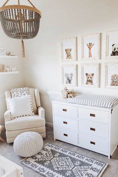 a baby's room with white furniture and pictures on the wall