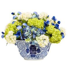 a blue and white vase filled with flowers