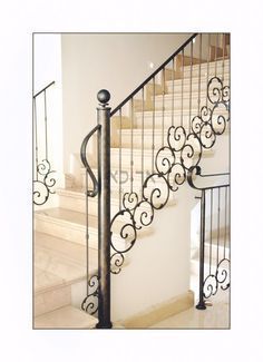 a staircase with wrought iron railing and handrail