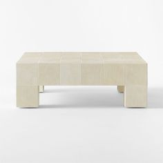 a white coffee table sitting on top of a white floor