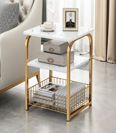 a white and gold end table with magazines on it