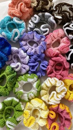 several crocheted scrunffles are arranged on a white surface