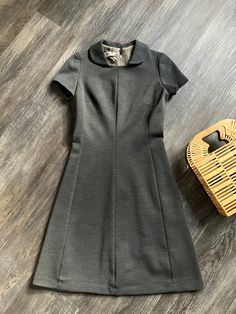 "1960's vintage A-line Marjorie Hamilton day dress in excellent condition. Gray wool, unlined with zipper closure and hook & eye at the back. This dress is very flattering on.  Has a fair amount of stretch. Princess seams and darts for form shaping. Measurements: Chest - 36\" Waist - 30\" Hem Opening - 50\" Length from high shoulder point - 39\" Across Shoulders - 14\" Sleeve length from shoulder seam - 6 1/2\"" Retro A-line Vintage Dress For Formal Occasions, Retro A-line Vintage Dress For Work, Vintage A-line Dress For Work, Classic Fitted Vintage Dress For Workwear, Fitted Vintage Dress With Short Sleeves For Work, Fitted Vintage Short Sleeve Dress For Work, Fitted Wool A-line Dresses, Fitted Short Sleeve Vintage Dress For Work, Fitted Knee-length Wool Dress