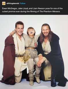 two men and a little boy are posing for a photo in front of a white background