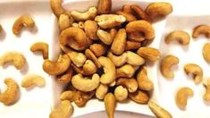 some cashews are in a white bowl