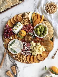 a platter filled with cheese, crackers and fruit