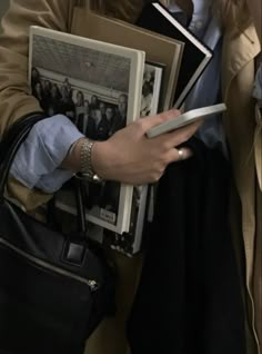 a woman holding several books in her hands