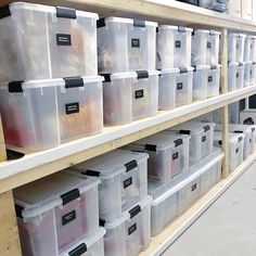 many plastic containers are stacked on the shelves