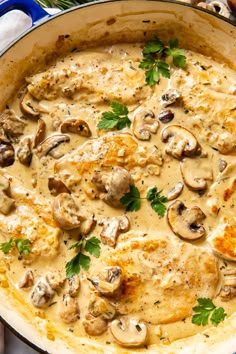 a pan filled with chicken and mushrooms covered in gravy