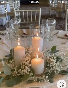 a table with candles and flowers on it