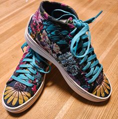 a pair of colorful shoes sitting on top of a wooden floor