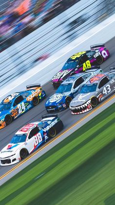 a group of cars driving down a race track