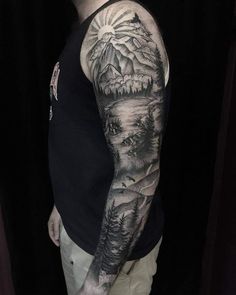 a man with a full sleeve tattoo on his arm