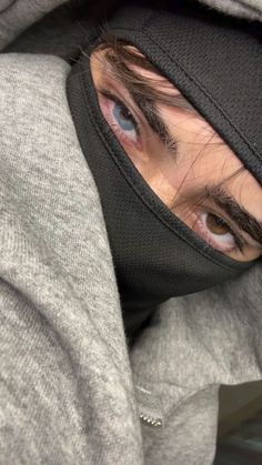 a man wearing a hoodie with his eyes wide open