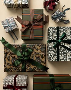 several wrapped presents with ribbons and bows are arranged on the wall next to each other